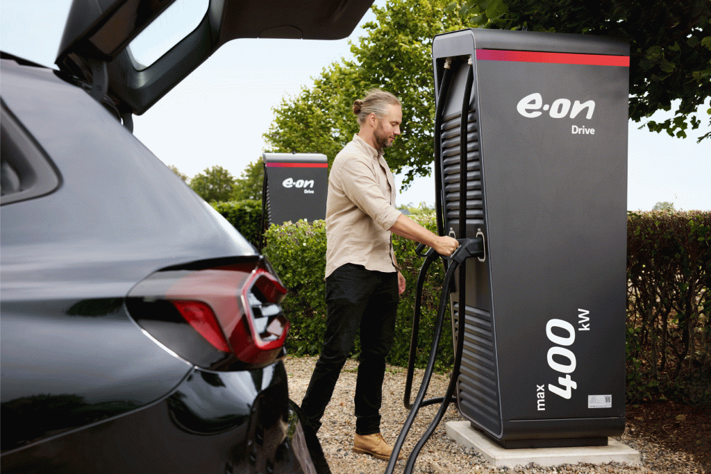 man uses electric car charging station